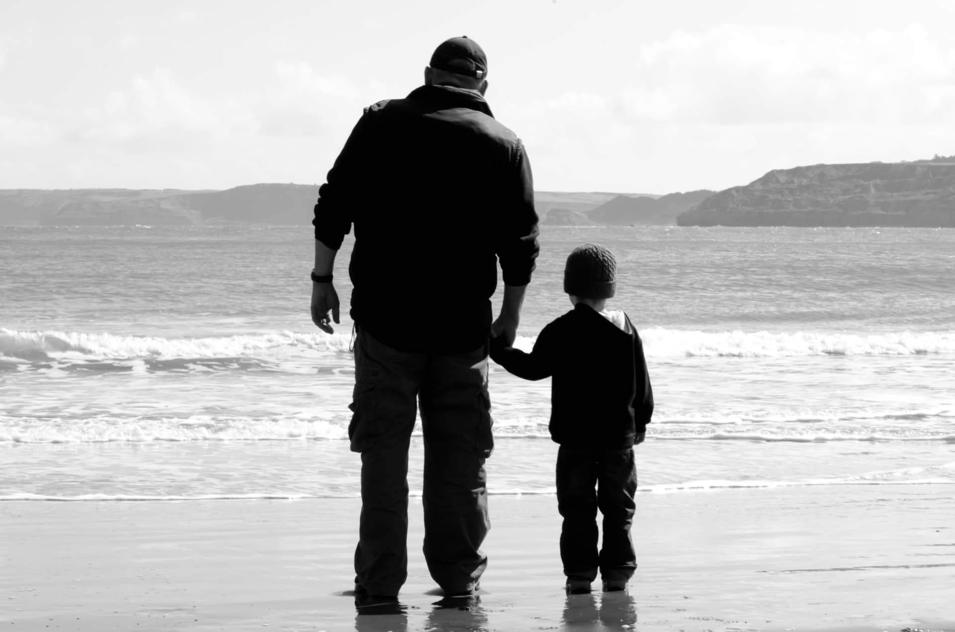 Grandfather and grandson on the sea shore